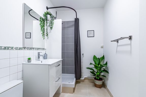 Détail des finitions de peinture murale dans une salle de douche